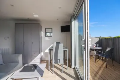 a living room with a couch and a table at Gannel Hideaway in Newquay