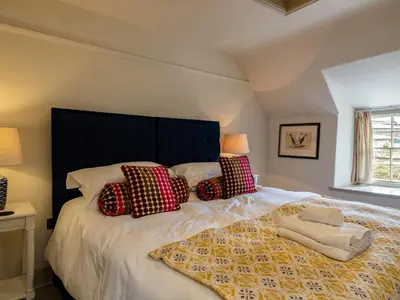 a bedroom with a large bed with pillows at Porthilly Greys in Padstow