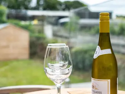a bottle of wine and a glass on a table at Porthilly Greys in Padstow