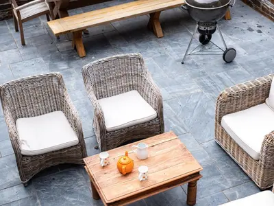 an overhead view of wicker chairs and a table with a pumpkin on it at Porthilly Greys in Padstow