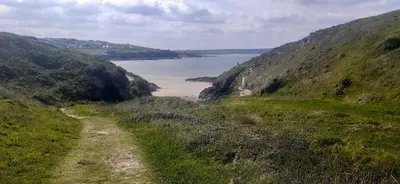 a path on a hill with a view of a body of water at Trewethen Cottage Barn 2 near Port Isaac in Port Isaac