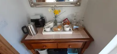 a table with cups and cups on top of it at Trewethen Cottage Barn 2 near Port Isaac in Port Isaac