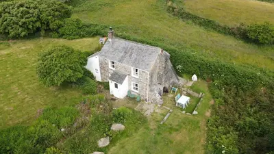 an aerial view of an old house in a field at Kitts Cottage, Redruth, Cosy Cornish Retreat in Redruth