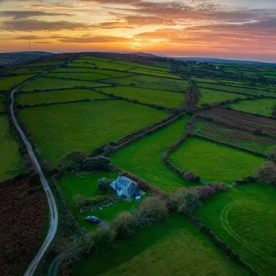 an aerial view of a field with a road at Kitts Cottage, Redruth, Cosy Cornish Retreat in Redruth