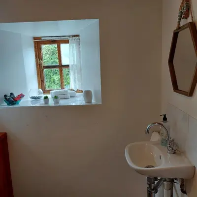 a bathroom with a sink and a window at Kitts Cottage, Redruth, Cosy Cornish Retreat in Redruth