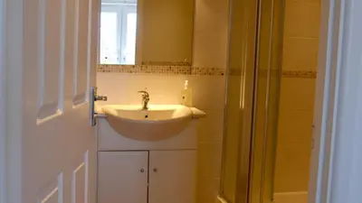 a bathroom with a sink and a mirror at Waves in Saint Columb Major