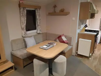 a small living room with a table and a couch at 58 Newquay View, Newquay Bay Resort in Porth