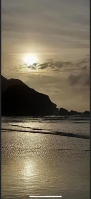 a sunset over a beach with the sun setting at 58 Newquay View, Newquay Bay Resort in Porth