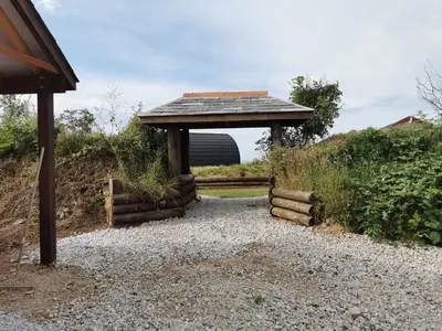 a gazebo with a roof on top of a gravel path at Glamping Pods Nr Port Isaac in Port Isaac