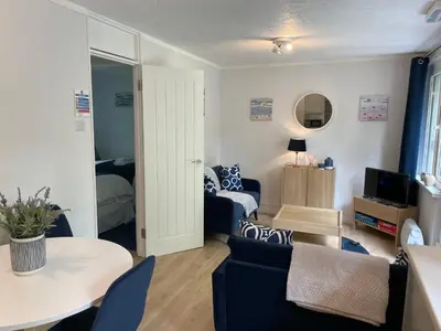 a living room with a couch and a table at Seaside Escape in St Ives