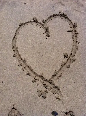 a heart drawn in the sand on the beach at Seaside Escape in St Ives
