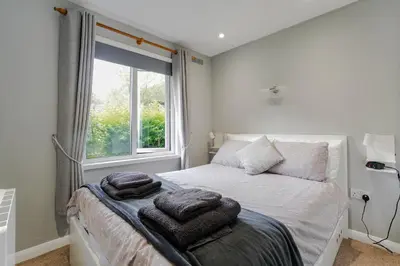 a bedroom with a bed with towels on it at Cornish Holiday - 91 Hengar Manor in Saint Tudy