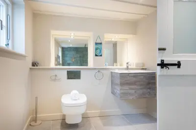 a bathroom with a toilet and a sink at Beach Cottage in St. Agnes