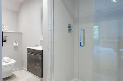 a bathroom with a shower and a toilet at Beach Cottage in St. Agnes