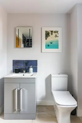 a bathroom with a sink and a toilet at Little Cedars House in Truro