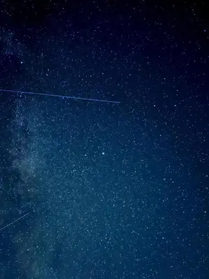 an airplane is flying in the night sky at Charming Guest House in Cornish Countryside in Bodmin
