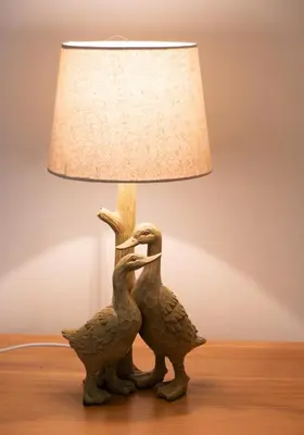 two birds statue next to a lamp on a table at Charming Guest House in Cornish Countryside in Bodmin