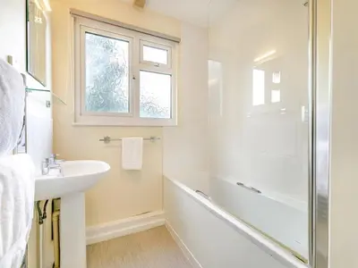 a bathroom with a tub and a sink and a shower at Beach View - Mount Brioni in Downderry