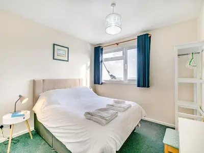 a bedroom with a bed with towels on it at Beach View - Mount Brioni in Downderry
