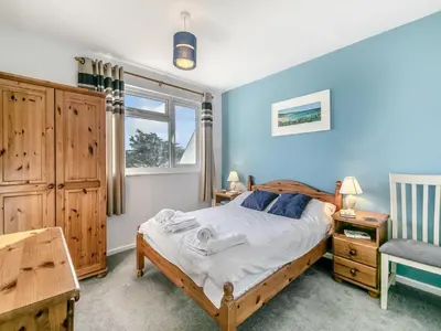 a bedroom with a bed and a desk and a chair at View of the Sea - Mount Brioni in Downderry