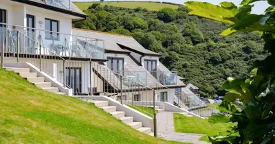a row of houses on a hill with stairs at Breakers - Mount Brioni in Downderry