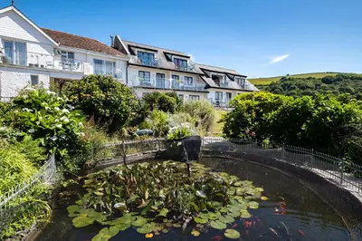 a koi pond in front of a building at Apartment 2 - Mount Brioni in Downderry