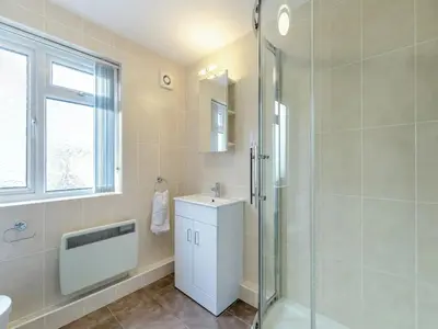 a bathroom with a glass shower and a sink at Apartment 2 - Mount Brioni in Downderry