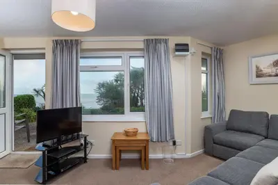 a living room with a couch and a television at Apartment 2 - Mount Brioni in Downderry