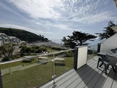 a balcony of a house with a view of the ocean at Sunrise Bay - Mount Brioni in Downderry