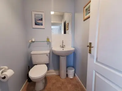 a small bathroom with a toilet and a sink at Sunrise Bay - Mount Brioni in Downderry