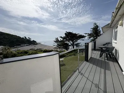 a balcony with a table and a view of a road at Sunrise Bay - Mount Brioni in Downderry