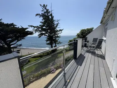 a balcony of a house with a view of the ocean at Trevian - Mount Brioni in Downderry