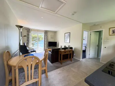 a living room with a table and a couch at Trevian - Mount Brioni in Downderry