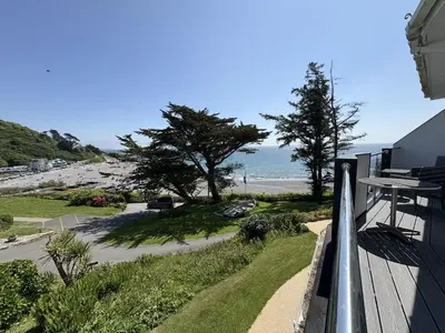 a view of the beach from the balcony of a house at Ocean Waves - Mount Brioni in Downderry