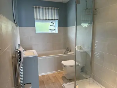 a bathroom with a toilet and a sink and a shower at Sea Gem - Mount Brioni in Downderry