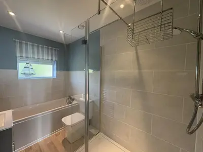 a bathroom with a shower with a toilet and a sink at Sea Gem - Mount Brioni in Downderry