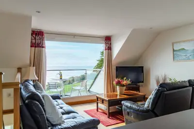 a living room with a view of the ocean at The Lookout - Mount Brioni in Downderry