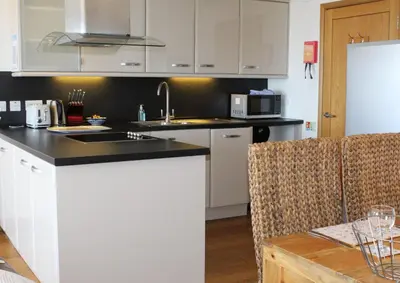 a kitchen with a sink and a counter top at Sunset Surf - Mount Brioni in Downderry