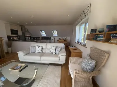 a living room with a white couch and two chairs at Lowena - Mount Brioni in Downderry