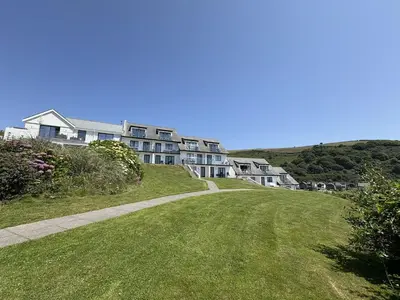a row of houses on a hill with a road at Lowena - Mount Brioni in Downderry