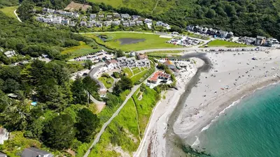 an aerial view of a beach with a crowd of people at Eddystone View - Mount Brioni in Downderry