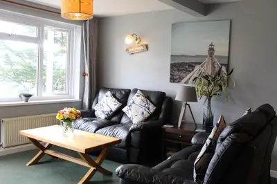 a living room with two couches and a coffee table at Cornish Riviera - Mount Brioni in Downderry