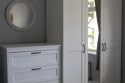 a bathroom with a mirror and a white dresser at Salty Air - Mount Brioni in Downderry