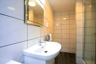 a bathroom with a sink and a mirror at Salty Air - Mount Brioni in Downderry