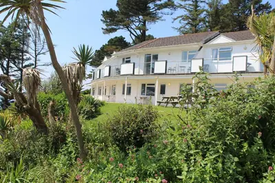a large white house with trees and plants at Salty Air - Mount Brioni in Downderry