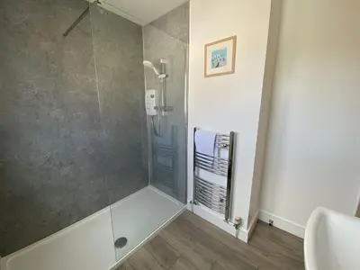 a bathroom with a shower with a glass door at Tide Watch - Mount Brioni in Downderry