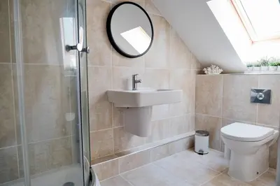 a bathroom with a sink toilet and a mirror at Finest Retreats - Tolcarne Stay - Luxury Newquay Apartment in Newquay