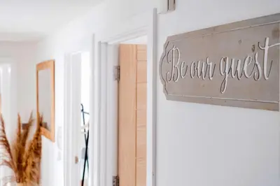 a sign that says basement guest on a wall at Finest Retreats - Tolcarne Stay - Luxury Newquay Apartment in Newquay