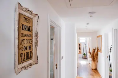a hallway with a picture on the wall at Finest Retreats - Tolcarne Stay - Luxury Newquay Apartment in Newquay