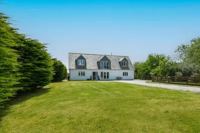 a large white house with a large yard at Treveth Lowen in Saint Minver